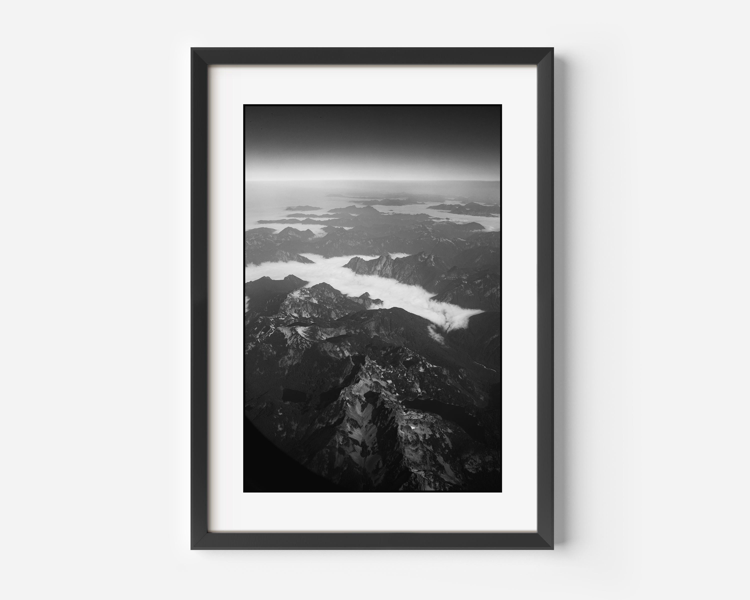 Colorado Rockies Fine Art Black and White Photography Print - Fog Settles in The Valleys of The Rocky Mountains as seen from above at 30,000 Feet.